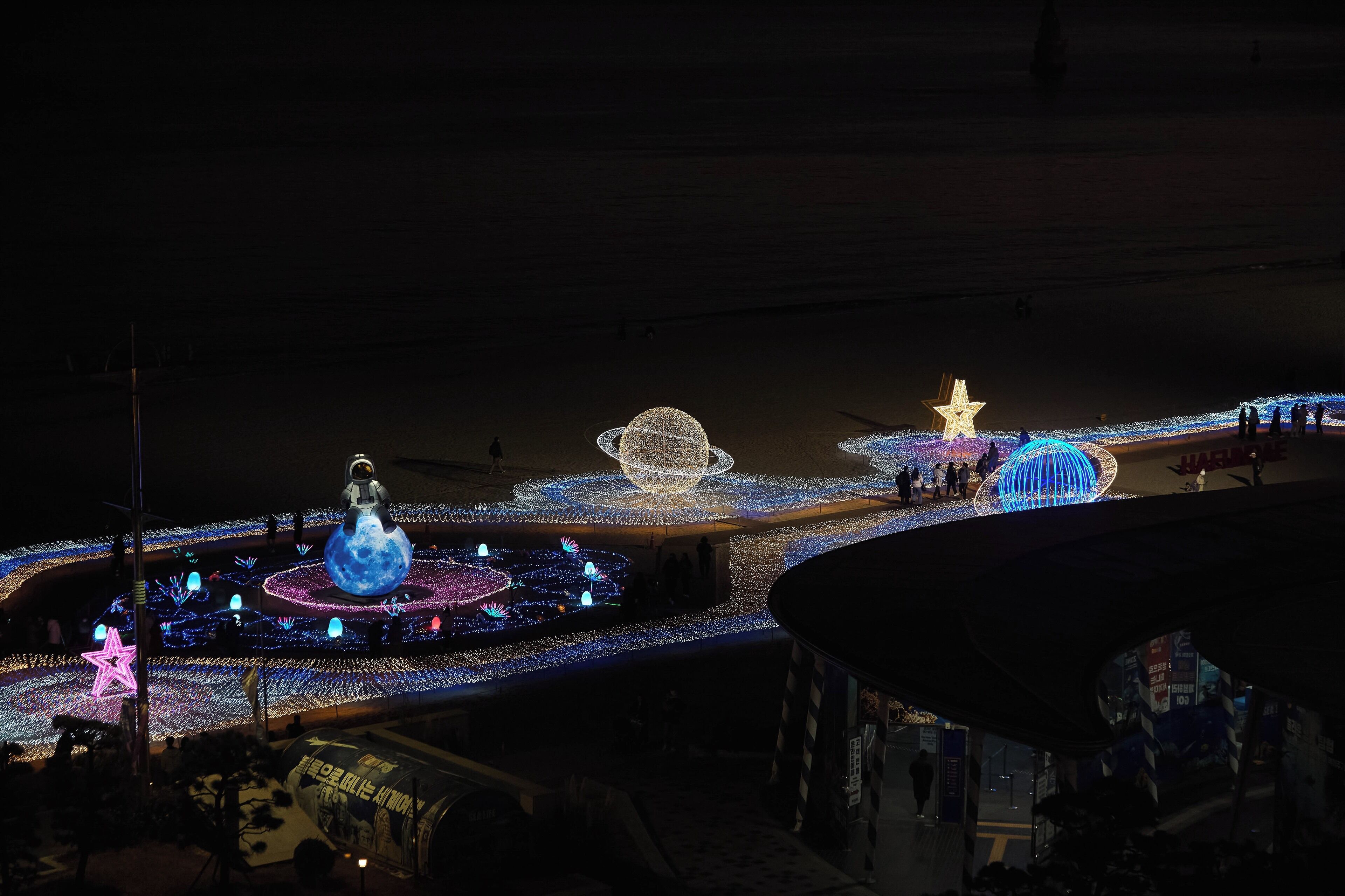 A large indoor space with a central circular area featuring illuminated structures and a star-shaped light on the ceiling.