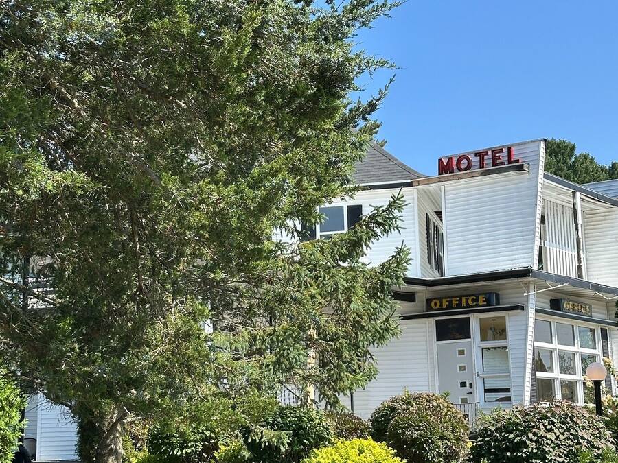 A white motel with a sign reading "Motel" and "Office" on the side.