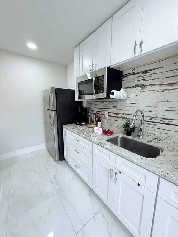 Fridge, microwave, stovetop, coffee/tea maker