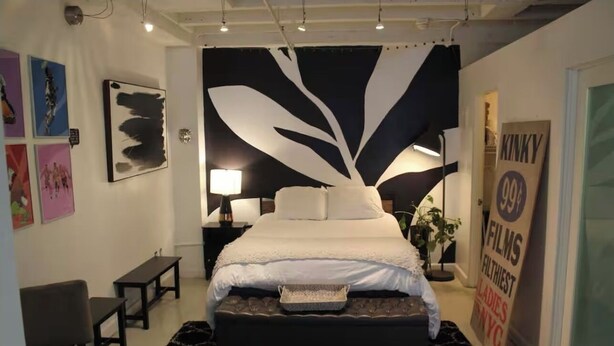 A bedroom with a large bed, a desk, a chair, and artwork on the walls. - Cozy Loft styled apartment in prime area of Downtown Los Angeles (Los Angeles)