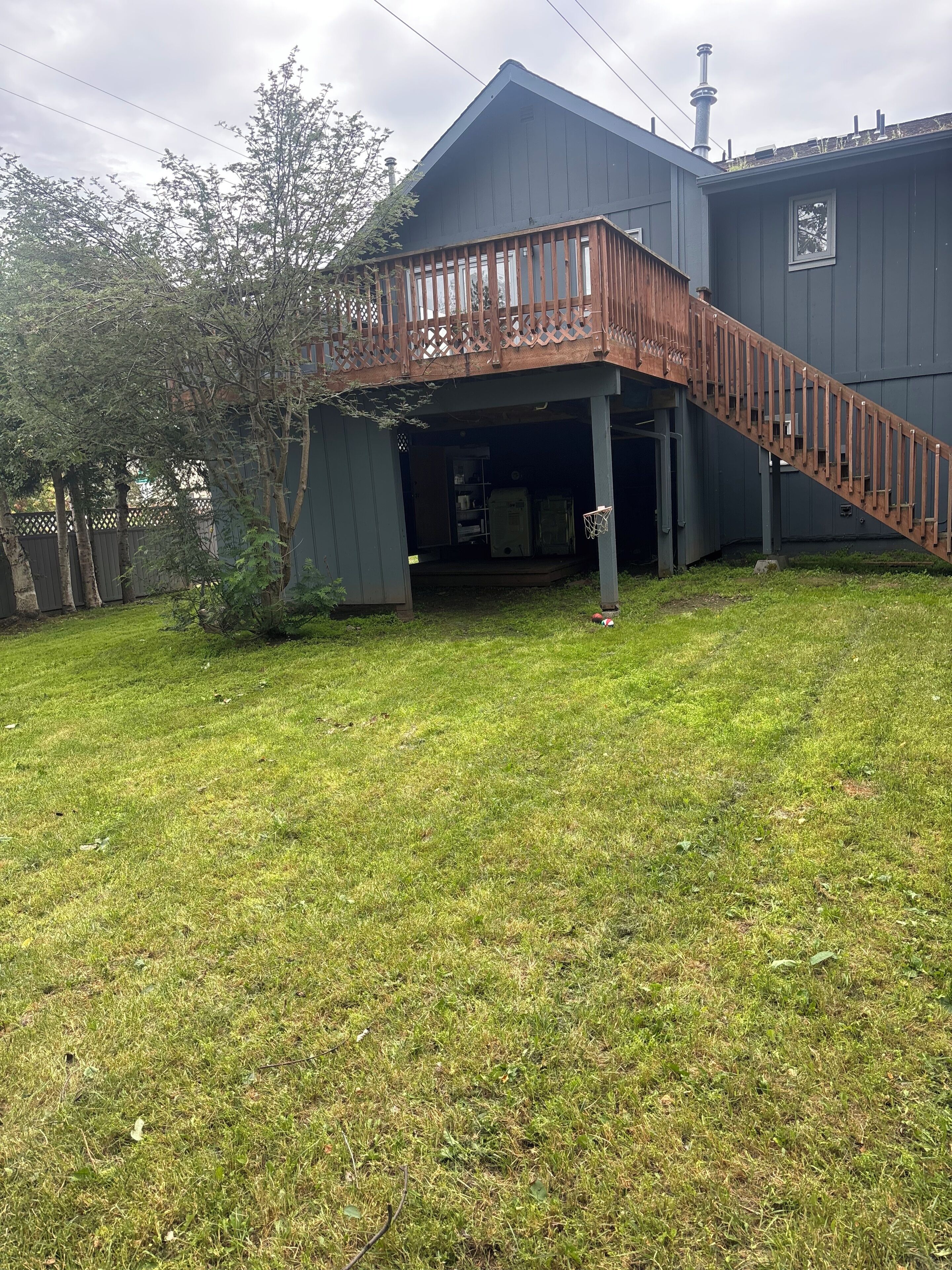 A house with a wooden staircase leading to a covered porch.