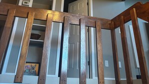 A staircase with wooden railings leading to a landing. - Relaxing-Retreat, Anchorage Getaway, Cozy & Newly Remodeled (Anchorage)