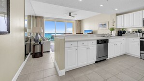 A modern kitchen with white cabinetry, a dishwasher, and a stainless steel oven. - BeachFront-5 Pools, Starbucks, Movies at Majestic Beach Resort (Panama City Beach)