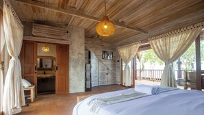 A spacious bedroom with a large bed, wooden ceiling, and a view of the outdoors. - Nico's House (Lembongan Island)