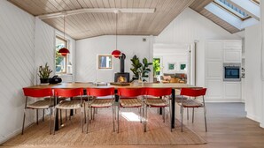 A modern kitchen with a central island, white cabinetry, and a skylight. - "Tede" - 1km from the sea by Interhome (Ebeltoft)