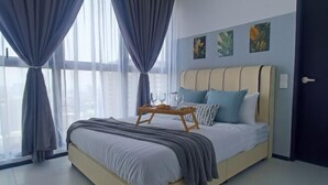 A modern bedroom with a large bed, a bedside table with glasses, and curtains. - Aesthetic 2BR @ Urban Suite (Infinite Pool & Gym) (George Town)