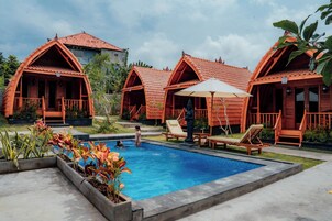 Una piscina al aire libre, tumbonas