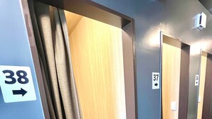 A hotel corridor with doors numbered 36, 37, and 38, leading to individual rooms. - Otemachi Kamon Hotel - Caters to Men - Hostel (Tokyo)