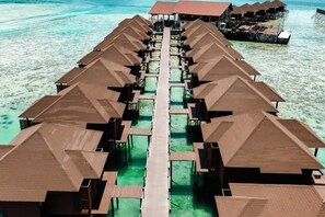 A row of overwater bungalows with a central walkway. - Sea Star Resort Semporna (Semporna)