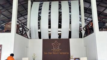 A reception area with a banner displaying the name 'Sea Star Resort Semporna.'