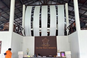 A reception area with a banner displaying the name 'Sea Star Resort Semporna.' - Sea Star Resort Semporna (Semporna)
