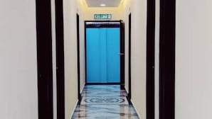 A hallway with a blue door labeled "CELLAR" and a patterned floor. - Sunstar Hotel (Batu Maung)