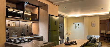 Microwave, stovetop, coffee/tea maker, cookware/dishes/utensils