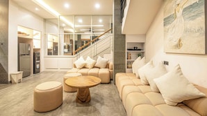 A modern living room with a sofa set, ottomans, and a coffee table. - Elegant 3BR Oasis in the Heart of Seminyak (Seminyak)