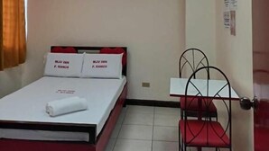 A hotel room with a bed, a desk, a chair, and skylights. - WJV INN RAMOS (Cebu City)