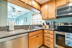 Fridge, microwave, stovetop, dishwasher - Steps to Sand: Condo w/ Pool Access in Cocoa Beach (Cocoa Beach)