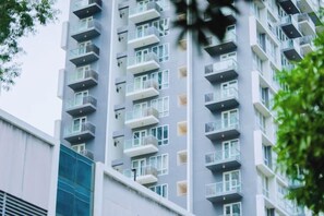 A multi-story residential building with balconies, windows, and a visible door. - WY Suites (Lapu-Lapu City)