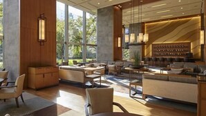 A spacious indoor area with a mix of seating arrangements, including sofas and tables, and a bar area with shelves. - Takanawa Hanakohro, a Member of Small Luxury Hotels of the World (Tokyo)