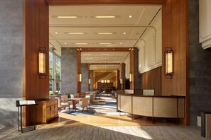 A spacious lobby with a reception desk, seating area, and a view into a corridor. - Takanawa Hanakohro, a Member of Small Luxury Hotels of the World (Tokyo)