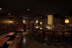 A dimly lit bar area with wooden seating and a bar counter. - Takanawa Hanakohro, a Member of Small Luxury Hotels of the World (Tokyo)