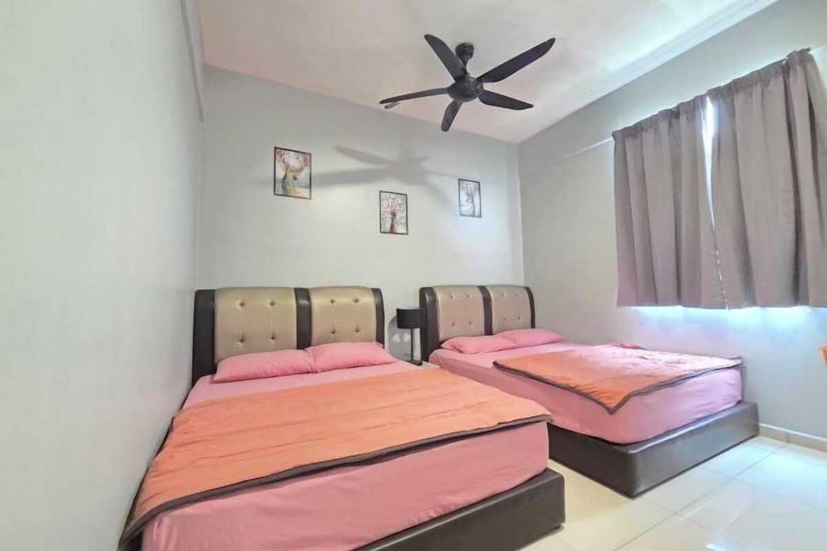 A bedroom with two beds, a ceiling fan, and a window with curtains.