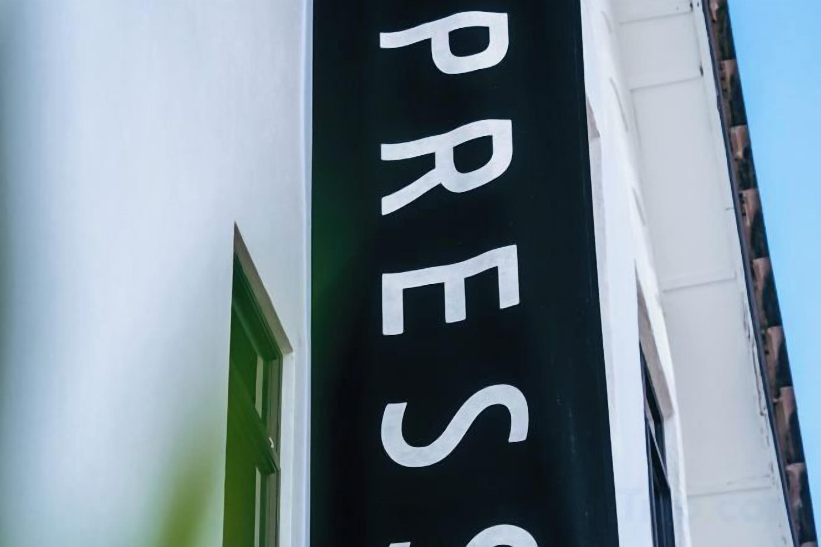 A building with a sign that reads 'PRESS'.
