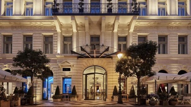 A grand hotel facade with classical architecture, a central entrance, and outdoor seating areas. - Aria Hotel Budapest by Library Hotel Collection (Budapest)