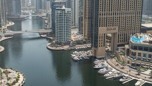 A marina with boats docked, surrounded by high-rise buildings, including one with "EMAAR" signage. - Marina Quays Residences - Dubai Marina (Dubai)