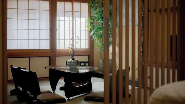 A traditional Japanese room with tatami flooring, a low table with a glass top, and sliding doors. - Rakuyado Turuhashi (Osaka)