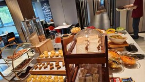 A buffet setup with various food items and condiments. - YIBISI (Qingdao)