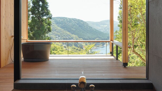 A modern room with a large window overlooking a scenic mountain landscape. - Casablanca Villa Hakone (Hakone)