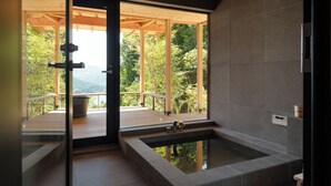 A modern bathroom with a large window, a built-in bathtub, and a wooden deck outside. - Casablanca Villa Hakone (Hakone)