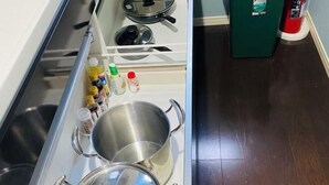 A kitchen with stainless steel appliances, a sink, and a green refrigerator. - Yodogawa Flower Private Accommodation (Osaka)