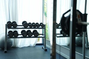 A gym with a rack of dumbbells and a barbell. - Signature Beach at The Arena Cam Ranh (Cam Ranh)