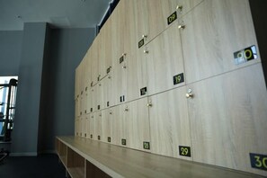 A row of wooden lockers with numbers on them. - Signature Beach at The Arena Cam Ranh (Cam Ranh)