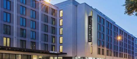 A multi-story hotel with a modern facade, large windows, and a prominent 'Courtyard' sign.