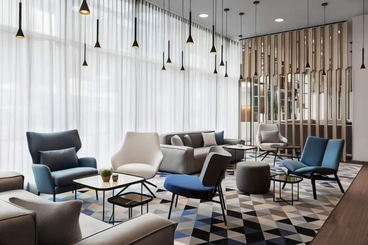 A modern lounge area with sofas, armchairs, and a coffee table.
