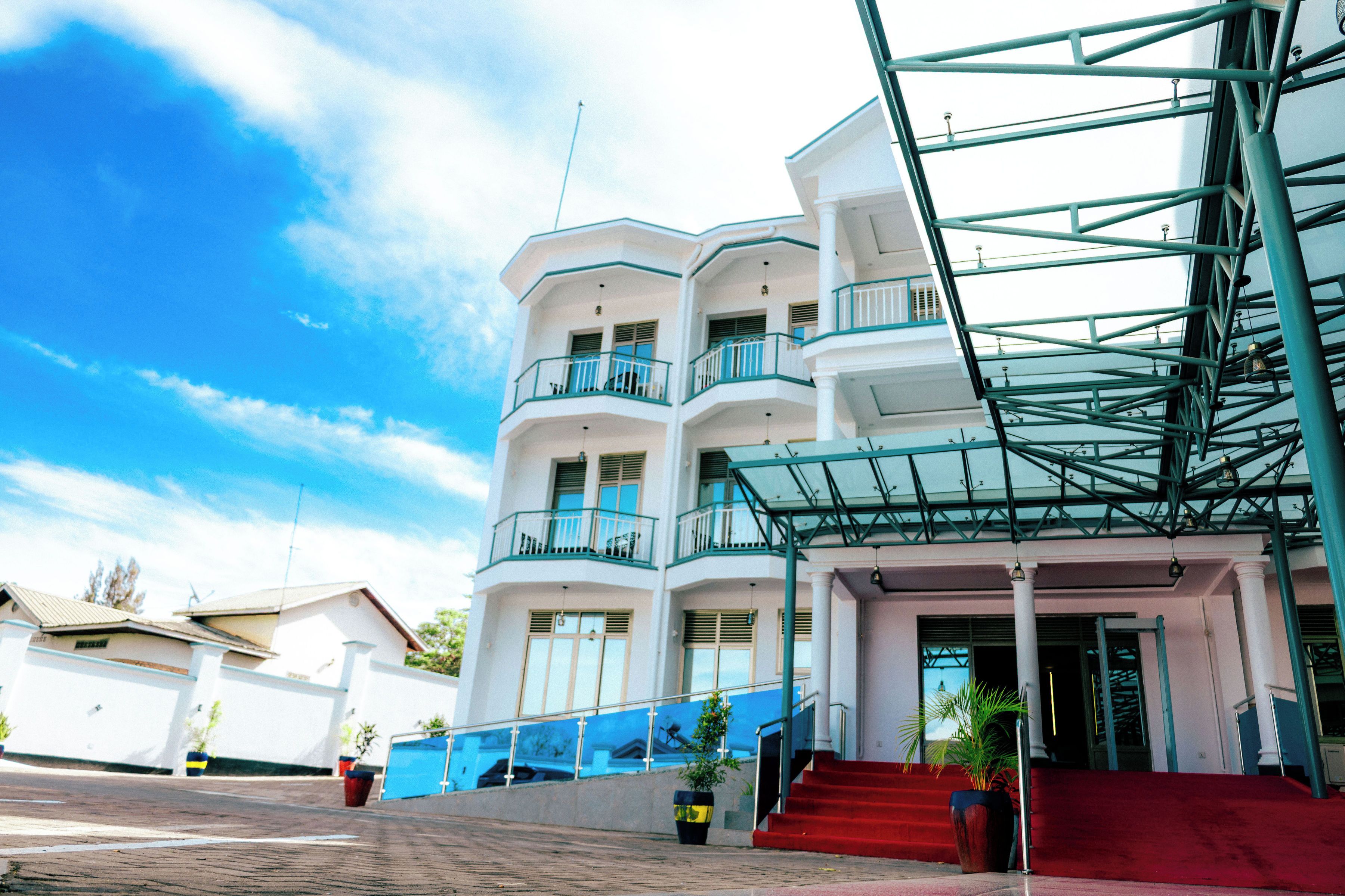 A multi-story building with balconies, a staircase, and a glass facade.