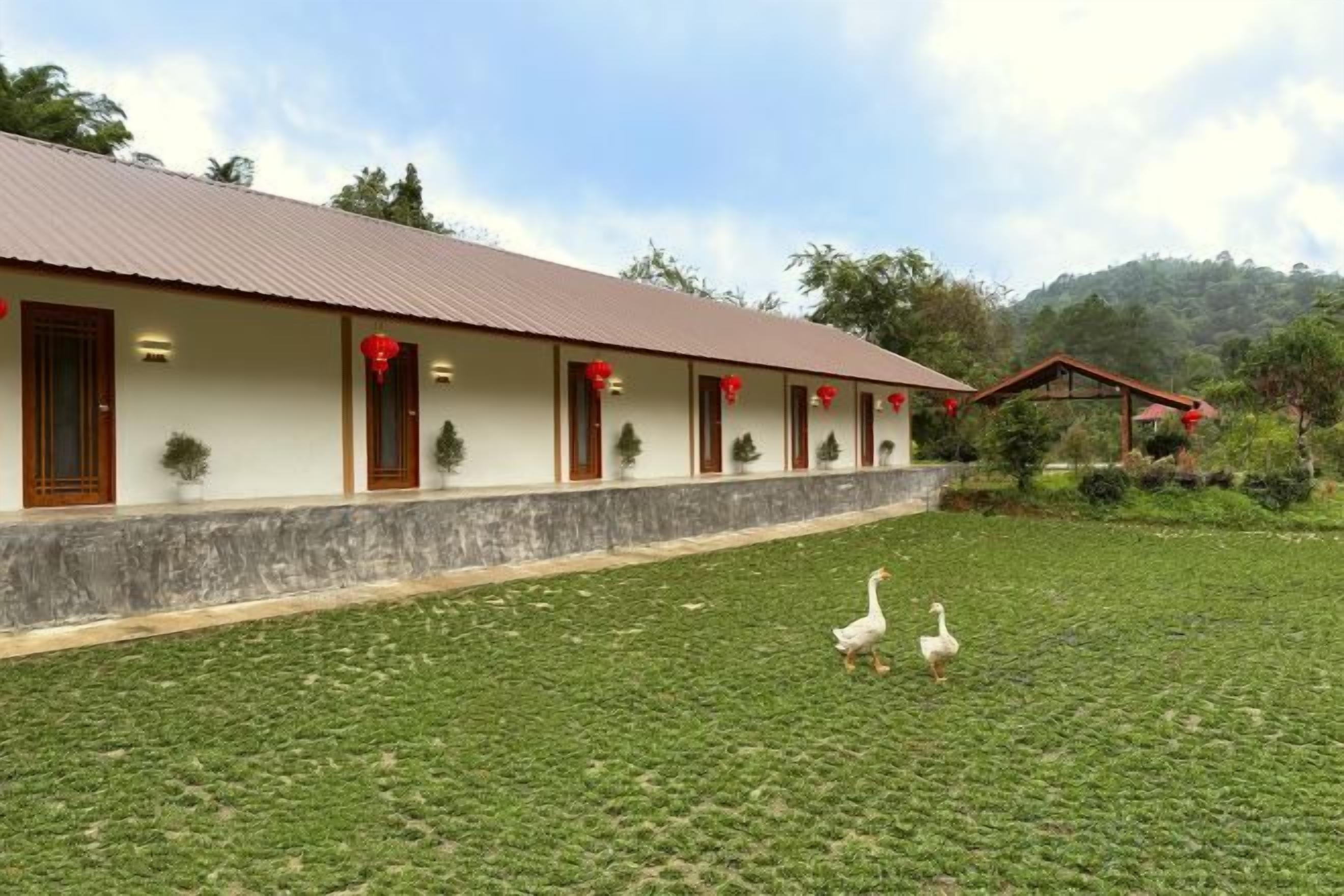A building with a row of windows and a covered area with a red roof.