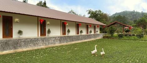 A building with a row of windows and a covered area with a red roof.