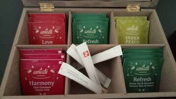 A wooden box containing six tea packets labeled 'Amarti Ayurveda'.
