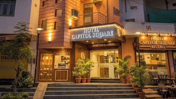 A hotel with a modern design, featuring a reception area, a lobby, and a bistro. - HOTEL CAPITOL SQUARE (Jaipur)