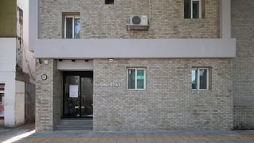 A building with a sign reading 'ONU-STAY' and a brick facade.