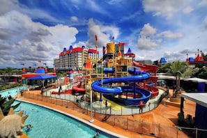 A water park with a pool, slides, and a building with multiple levels. - Sunway Grid by RR JBcity (Iskandar Puteri)