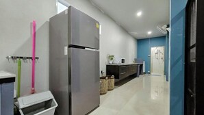 A modern kitchen with a stainless steel refrigerator, a microwave, and a sink. - Bunk Ubon Hostel (Ubon Ratchathani)