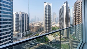 A cityscape with modern high-rise buildings, including a prominent tower labeled "EMAAR". - Marquise Square Towers - Business Bay (Dubai)