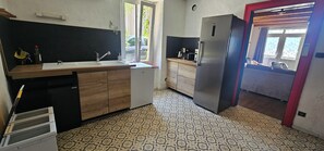 Cocina compacta con lavamanos, refrigerador pequeño y microondas.