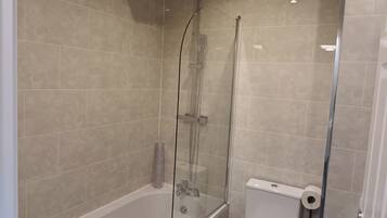 Combined shower/bathtub, deep-soaking bathtub, hair dryer, towels