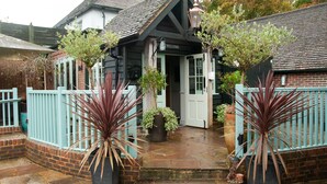 A traditional building with a welcoming sign, a brick exterior, and a gated entrance.