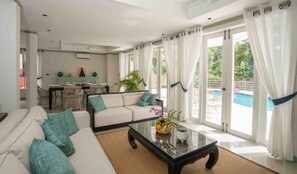 Villa, Pool View | Living area | 55-inch TV with digital channels